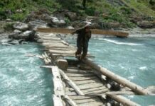 Through the lense Braving the odds: These women cross turbulent water currents while ferrying firewood on their shoulders in north Kashmir