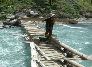 Braving the odds: These women cross turbulent water currents while ferrying firewood on their shoulders in north Kashmir