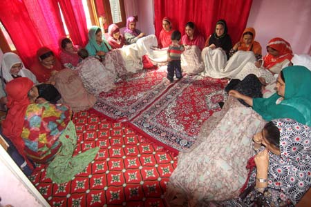 a group of women yarning pashmina (FUMB) in a remote village of baramulla district .majority of women yarns pashmina to earn peanut amount to support their respective families