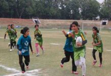 Girls playing Rugby at the outdated Bakshi Stadium in Srinagar