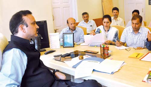 Sajad A Kichloo, MoS for Industries and Commerce and Home during a meeting with officials.