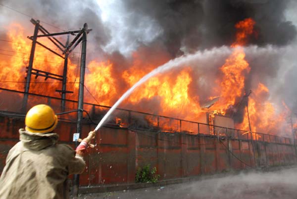 A Fireman in action to douse flames that erupt in Civil Secretariat building on Thursday morning: Photo: Bilal Bahadur 