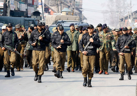Local people washing the blood off the road after three youngsters and a policeman were killed in the shootout at Qammerwari Srinagar.