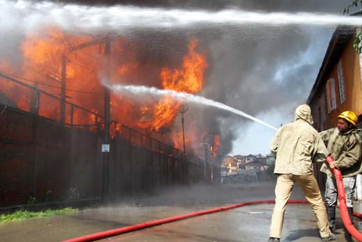 Fire fighters dousing the flames near Srinagar.