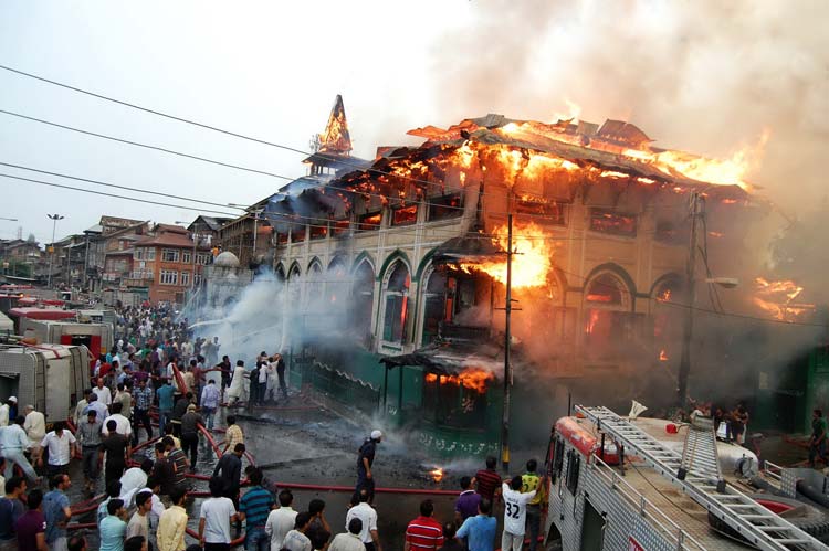 Fire Fighters dousing flames in Dastgeer Sahib Shrine in Khanyar. Pic: Bilal Bahadur