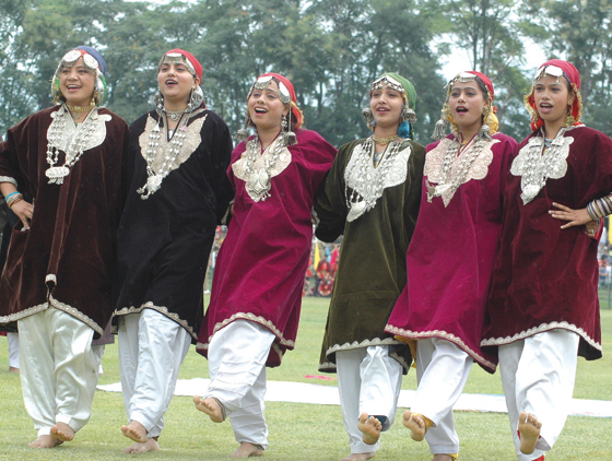 Kashmiri girls performing in traditional Pherans during a state organized function.  Pic: Bilal Bahadur