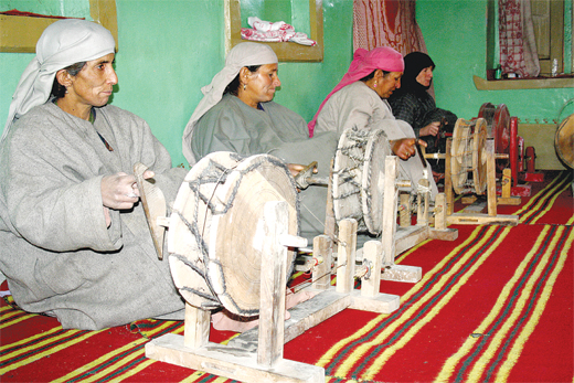 Kashmiri Women on spinning wheels