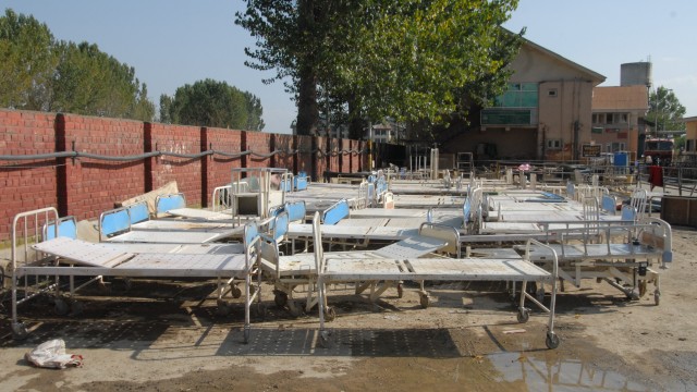 Rows of flood-washed hospital beds left to dry in Srinagar's SKIMS Bemina