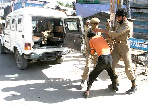 A youth being detained by policemen in Islamabad in this file photo.