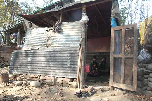 With their house devoured in the diluge, this young couple now lives inside this shed. Pic: Bilal Handoo