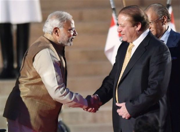 Pakistan premier, Mian Nawaz Sharief, greeting Narendra Modi on his being swore-in as PM of India in New Delhi in 2014.