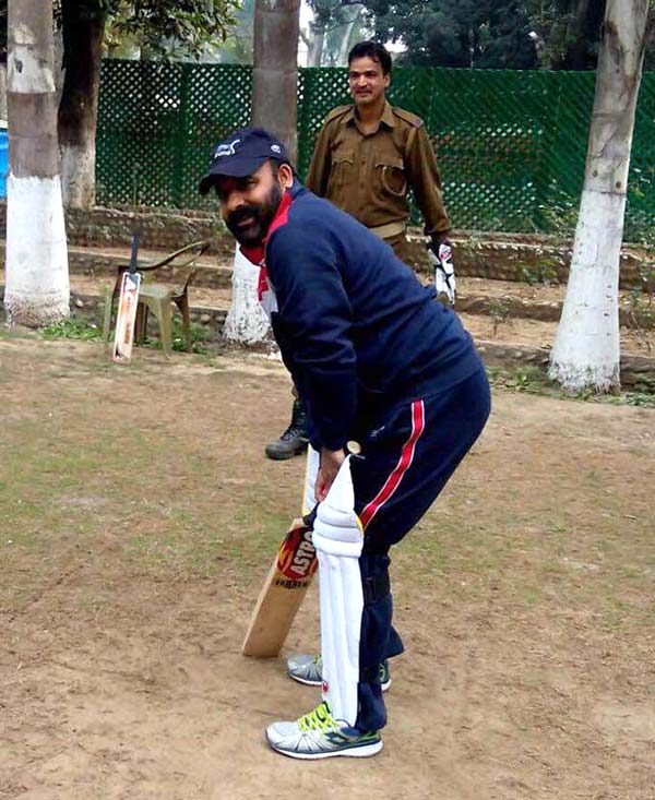 Killing Time: Former BJP minister Bali Baghat playing cricket with cops at his official residence in Jammu.