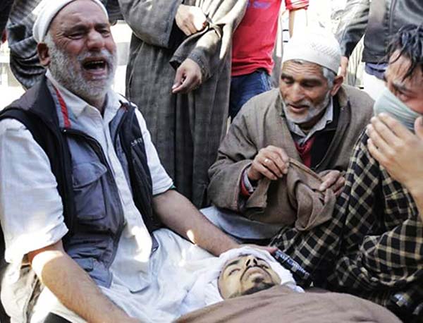 Inconsolable: Relatives of one of the two slain youths wail over his body.