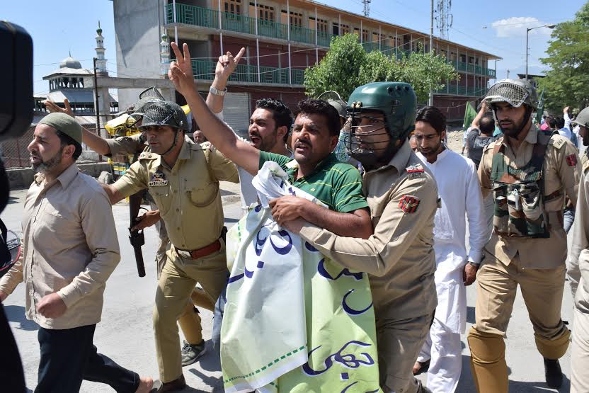 Police detain a Hurriyat Conference (m) activist on way to Eidgah on May 21, 2016.