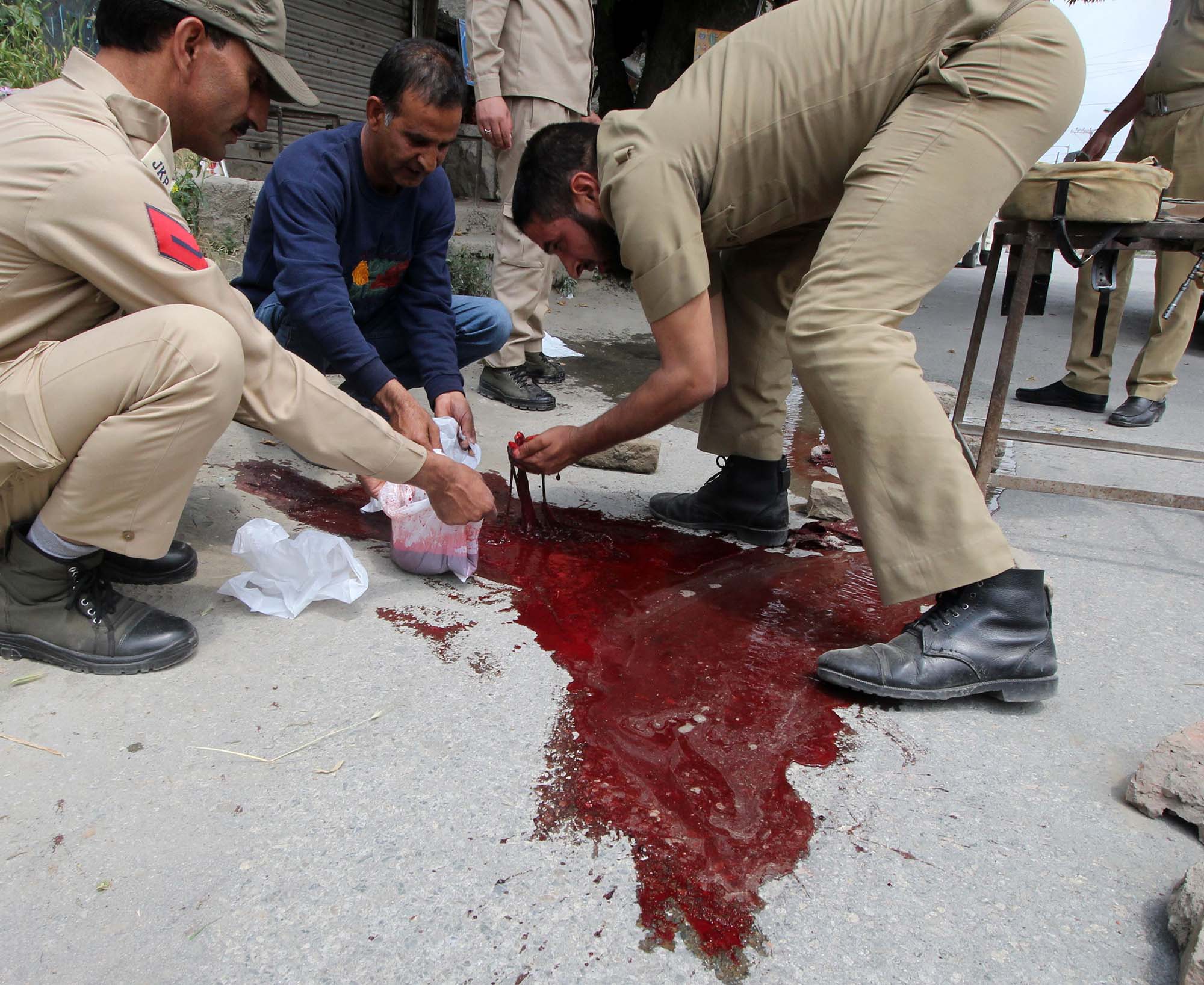 Blood of policemen is collected in a polythene bag by cops in Zadibal area of Srinagar on May 23, 2016. (KL Image: Bilal Bahadur)