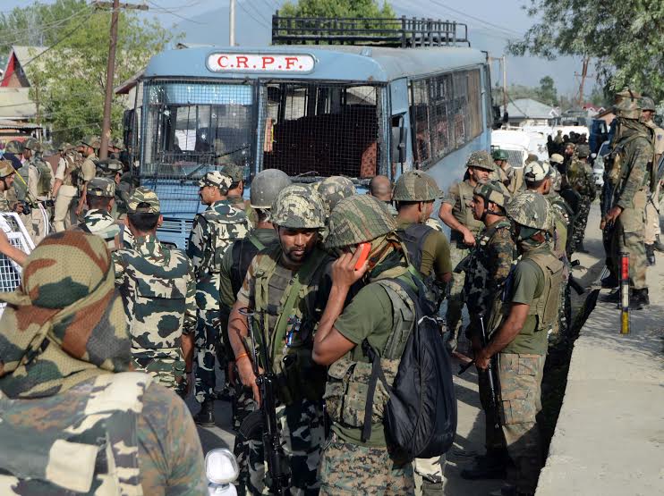CRPF men standing near the bus which came under attack at Pampore on last Saturday.