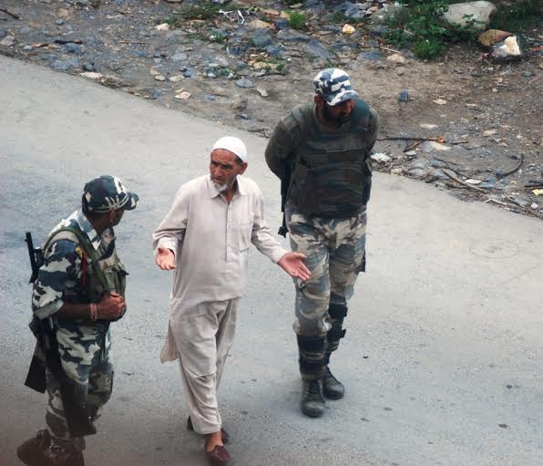 An elderly man arguing with forces in Dooru Islamabad on Saturday.