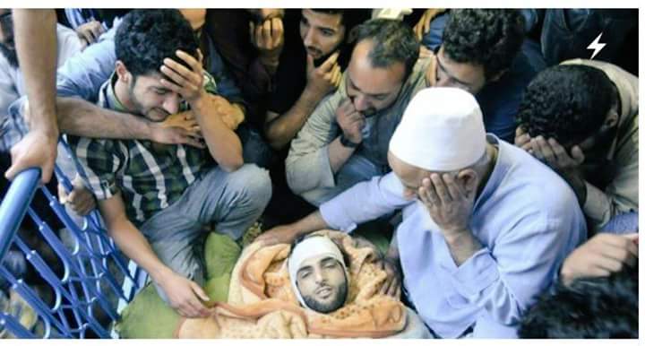 Slain Burhan Wani's body at his home on Saturday while his father and younger brother wail. (KL Image courtesy: Waseem Andrabi)