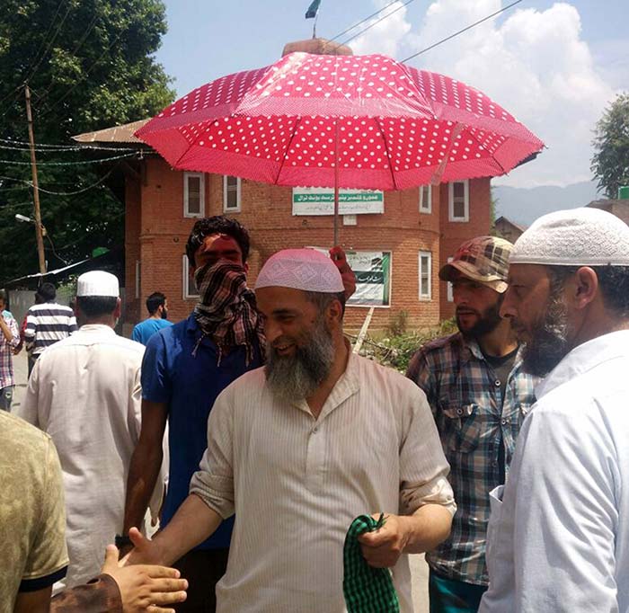 In Tral, everbody wants to shake hands with Burhan’s father, Muzaffar Wani.