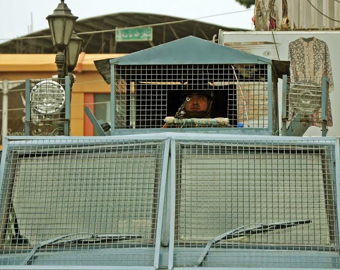 paramilitary soldiers stand guard inside a armed vehicle during curfew in Srinagar, Friday July 15, 2016. Curfew imposed in the seventh consecutive day PHOTO BY BILAL BAHADUR