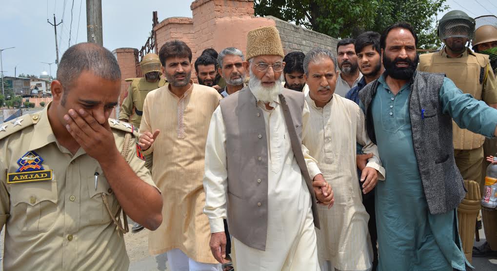 Dr Nayeem Geelani holding left hand of APHC chief Syed Ali Geelani in this KL file Image.