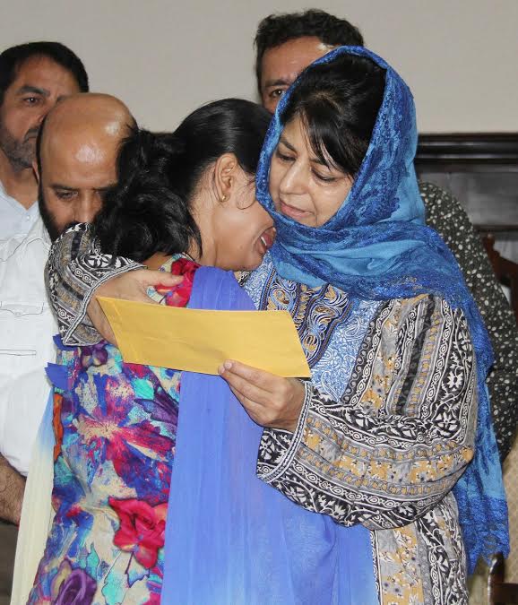 CM with a lady while handing over SRO