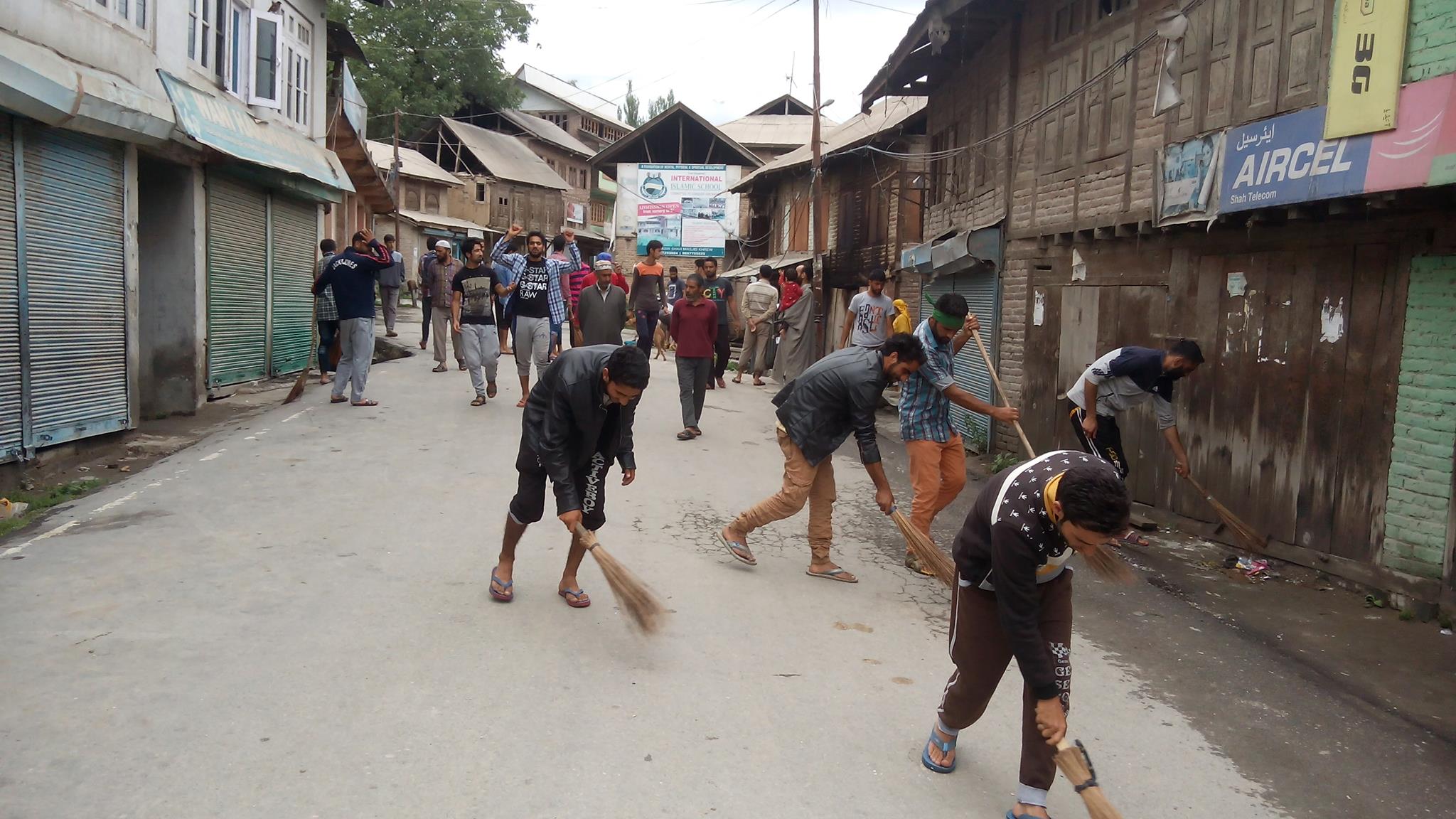 Youths cleaning Khrew area of Srinagar on Sunday on Hurriyat call.
