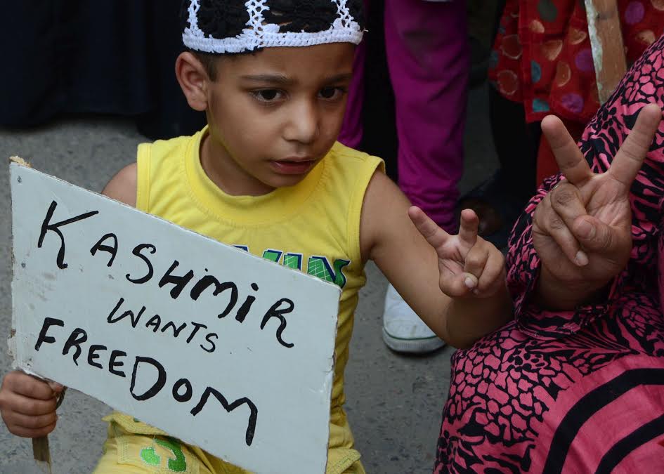 A child showing victory singe during  a protest rally against the killing  67 civilians in Dalgate area of Srinagar on Friday 19 August 2016.Separatists had asked people to march to Beerwah on Friday where four persons were killed by forces a day after Independence day.PHOTO BY BILAL BAHADUR