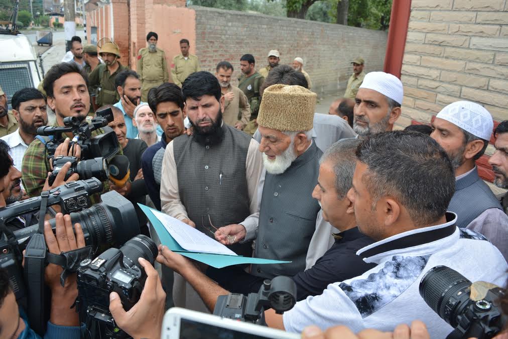 Geelani reading 'Go Home' letter to Army based in Kashmir before being arrested ahead of his planned march to 15 Corps Army headquarter at Badambagh in Srinagar on August 27, 2016.