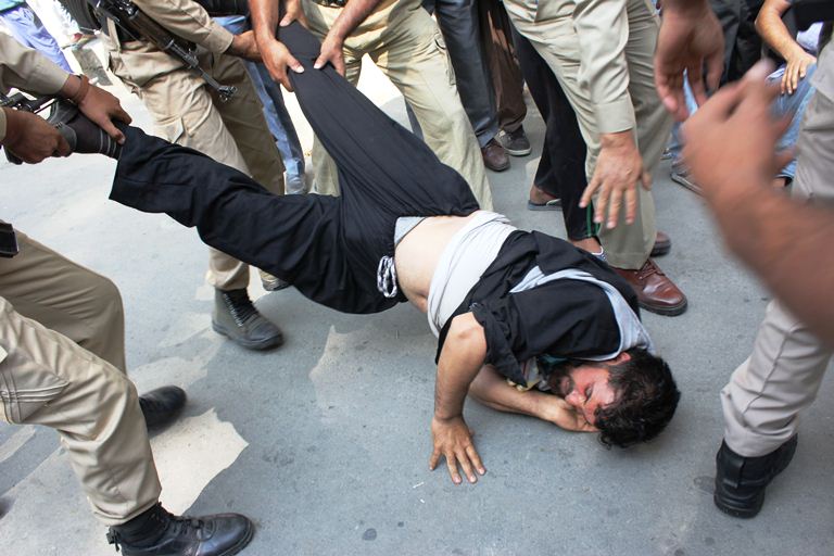 An AIP activist being dragged by cops during protest march towards UN Office Srinagar on Sep 26, 2016. (KL Images: Bilal Bahadur)