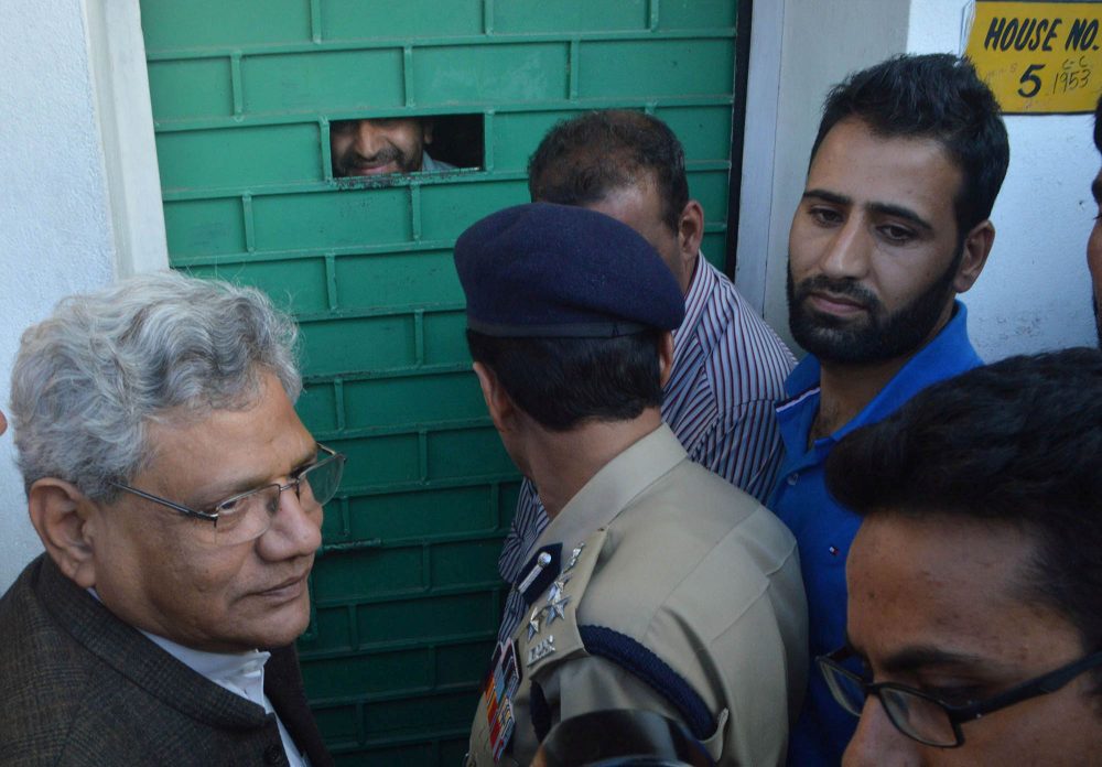 A worker of Chairman of the hardline faction of All Parties Hurriyat (Freedom) Conference, Syed Ali Geelani tells Sitaram Yechury, the General Secretary of Communist Party of India (Marxist), from inside a door that Geelani would not meet any member of the All Party delegation of parliamentarians in Srinagar, 04 September 2016. PHOTO BY BILAL BAHADUR