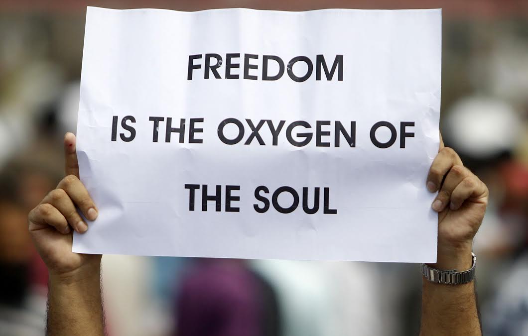 A mourner carrying a placard in the funeral of school-boy Danish Sulatn in Eidgah Srinagar. (KL Image: Bilal Bahadur)