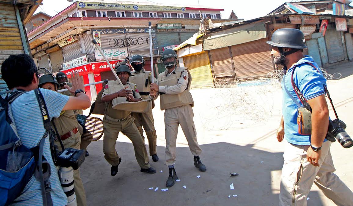 J&K Police cops attack photo-journalists in Batamaloo on September 03, 2016. (KL Images: Bilal Bahadur)