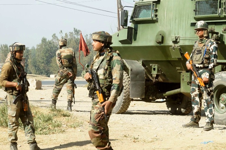 Army soldiers stand alert as an encounter started between forces and suspected militants hiding in a Hostel Building of J&K EDI on Oct 10, 2016 at Sempora Pampore. (KL Image: Bilal Bahadur)