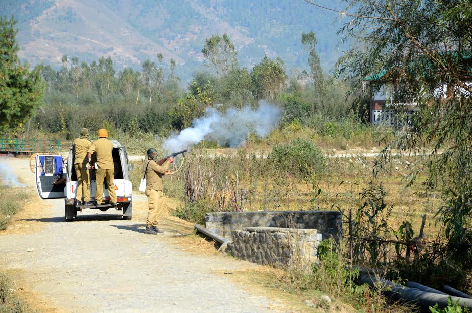 Men in uniform fire ear gas shells to disperse of people who tried to hold freedom rally in Livar on 10 Oct 2016. (KL Image: Shah Hilal)
