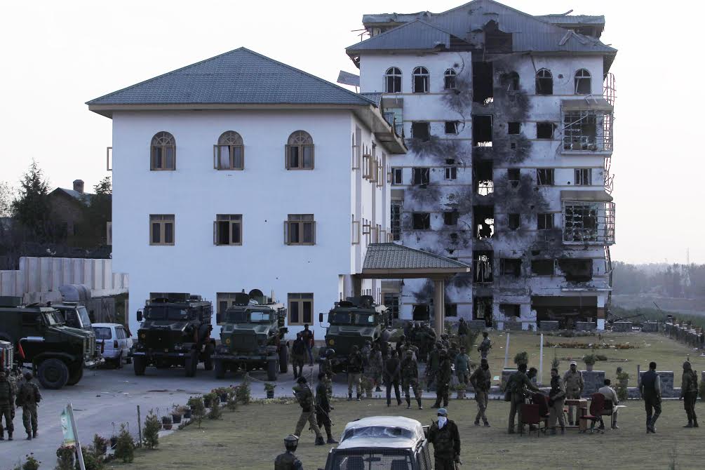 Para-troopers flown from Delhi along with other other army soldiers inside the EDI premises at Pampore on day third of the encounter. The damaged hostel building stand behind where the two unidentified militants were killed during 56-hour long gun battle. The encounter started on morning of October 10, 2016. (KL Image: Bilal Bahadur)