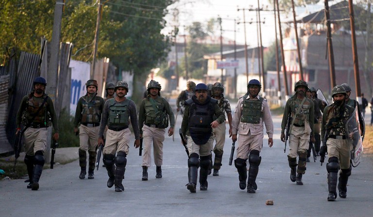 Police and para-military CRPF men march on a Srinagar road on Oct 8th 2016 following killing of a 12-year-old city school boy following which government imposed curfew in summer capital. (KL Image: Bilal Bahadur)