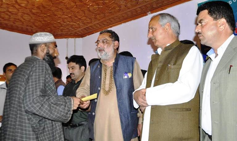 FinMIn Drabu distributing cheques to various Construct Board benificieries in Pulwama