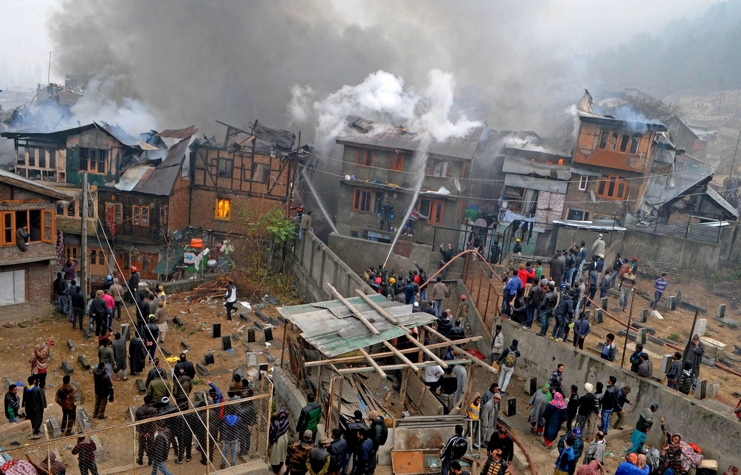 Firefighters trying to control flames at Buchwara, Dalgate. Photo: Bilal Bahadur