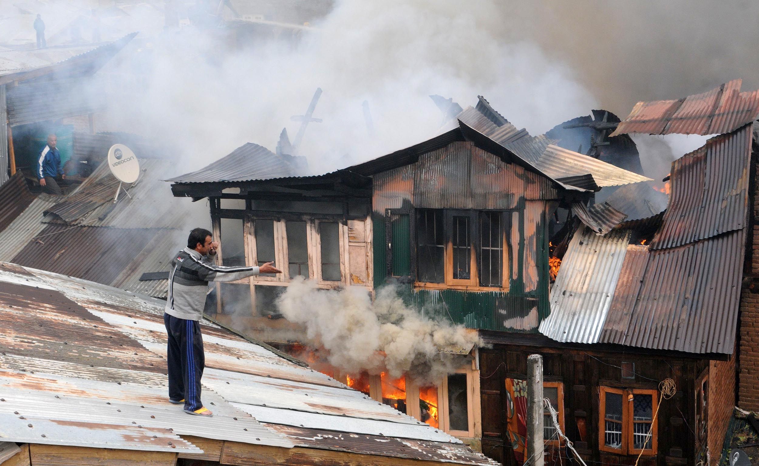 A local trying to help firefighters at Buchwara, Dalgate. Photo: Bilal Bahadur