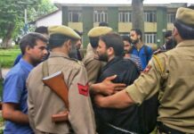 Handcuffed, a slain cops PSA detained son writes his exam