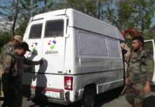 Police and army personnel inspect J&K Bank's cash delivery vehicle after it was attacked by suspected militants in Kulgam's Pombai village on Monday evening. The attack left 5 policemen and 2 bank employees dead.