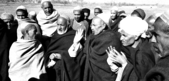 An undated photograph showing the village elders in a discussion.