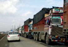 Choked Artery Long line of stranded trucks on a road. KL Image by Bilal Bahadur