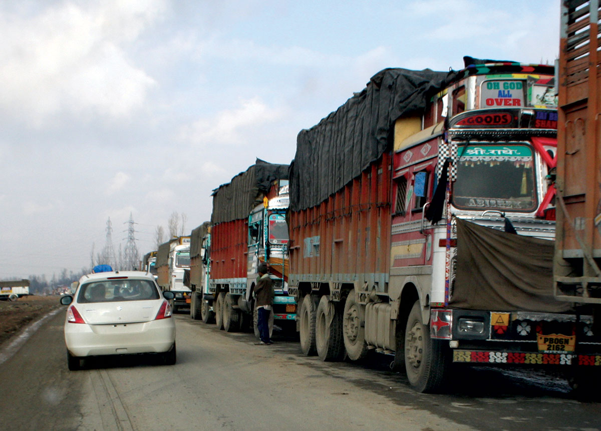 Long line of stranded trucks on a road. KL Image by Bilal Bahadur