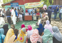 Officials with villagers during BAck to Village programme in Bandipora district.