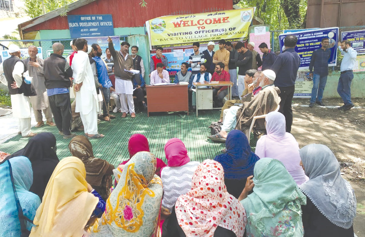 Officials with villagers during BAck to Village programme in Bandipora district.