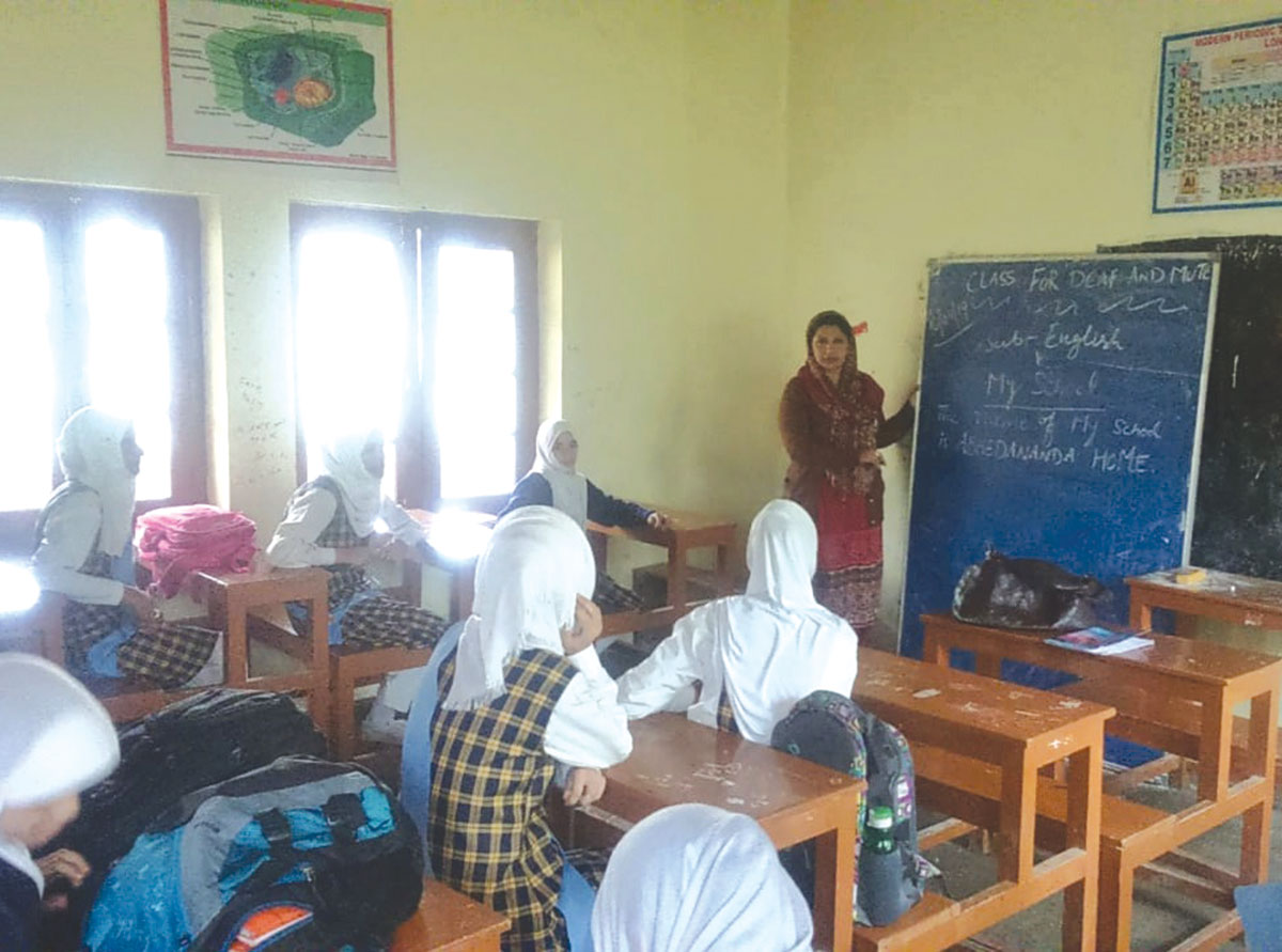 Farzana teaching deaf and dumb students at school.