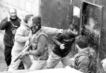 Photojournalist being beaten by forces during covering an encounter in Srinagar.
