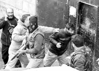 Photojournalist being beaten by forces during covering an encounter in Srinagar.